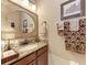 Bathroom features a decorative mirror, vanity with granite countertop, and neutral paint at 2944 Oriole Dr, Sarasota, FL 34243