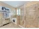 Bright bathroom featuring a glass shower, tub, and decorative zebra wall art at 2944 Oriole Dr, Sarasota, FL 34243
