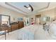 This primary bedroom features neutral walls, tray ceiling, ceiling fan, and an ensuite bathroom at 2944 Oriole Dr, Sarasota, FL 34243