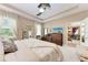 This primary bedroom features neutral walls, tray ceiling, ceiling fan, and an ensuite bathroom at 2944 Oriole Dr, Sarasota, FL 34243