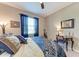 Inviting bedroom boasts neutral walls, a ceiling fan, and patterned bedding, creating a relaxing and comfortable space at 2944 Oriole Dr, Sarasota, FL 34243