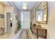 Bright foyer with tiled flooring, a decorative mirror, a patterned rug and natural lighting at 2944 Oriole Dr, Sarasota, FL 34243