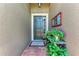 Welcoming front entry with a decorative flower pot, stylish mirror and a paved entrance at 2944 Oriole Dr, Sarasota, FL 34243
