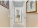 Hallway with neutral walls, white doors, access to multiple rooms, and carpeted floor at 2944 Oriole Dr, Sarasota, FL 34243