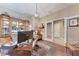 The home office features unique furniture pieces, natural lighting, hardwood flooring, and access to the hall at 2944 Oriole Dr, Sarasota, FL 34243