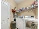 Well-organized laundry room equipped with a washer, dryer, storage shelves, and practical features for efficient chores at 2944 Oriole Dr, Sarasota, FL 34243