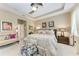Spacious main bedroom featuring tray ceilings, neutral color scheme, and cozy seating area at 2944 Oriole Dr, Sarasota, FL 34243
