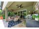 Charming covered patio featuring an outdoor kitchen, ceiling fans, and a dining area perfect for entertaining guests at 2944 Oriole Dr, Sarasota, FL 34243