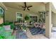 Relaxing screened patio with ceiling fans, a dining area, and an outdoor kitchen, ideal for entertaining guests at 2944 Oriole Dr, Sarasota, FL 34243