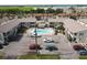 A high-angle view of the complex featuring the pool, building layout, and surrounding parking area at 320 Base E Ave # 215, Venice, FL 34285