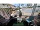 Outdoor balcony with view of community pool, chairs, and small table at 320 Base E Ave # 215, Venice, FL 34285