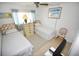 Comfortable bedroom with twin beds, tiled floors and a ceiling fan at 320 Base E Ave # 215, Venice, FL 34285