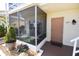 Inviting condo entrance with screen enclosed porch and unit 215 address at 320 Base E Ave # 215, Venice, FL 34285