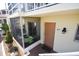 Inviting condo entrance with screen enclosed porch, neutral paint, and unit 215 address at 320 Base E Ave # 215, Venice, FL 34285