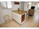 Bright kitchen with breakfast bar, seating, and adjacent living area at 320 Base E Ave # 215, Venice, FL 34285