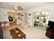 Open concept living area with tile floors, seating and screened porch access at 320 Base E Ave # 215, Venice, FL 34285