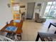 Cozy living room featuring tile flooring, a dining table and a lounge chair at 320 Base E Ave # 215, Venice, FL 34285