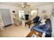 Cozy living room with tile floors, ceiling fan and screened porch access at 320 Base E Ave # 215, Venice, FL 34285
