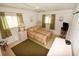 Comfortable bedroom with a ceiling fan, two windows and tiled floor at 320 Base E Ave # 215, Venice, FL 34285