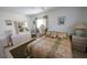 Comfortable bedroom with a ceiling fan, two windows and tiled floor at 320 Base E Ave # 215, Venice, FL 34285