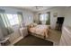 Comfortable bedroom with a ceiling fan, two windows and tiled floor at 320 Base E Ave # 215, Venice, FL 34285