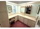 Bathroom featuring vanity with great counter space, a lighted mirror, and ample storage at 344 Mariner Dr, North Port, FL 34287
