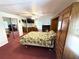 Comfortable bedroom featuring a king-size bed, a mirrored closet, and soft, plush carpeting at 344 Mariner Dr, North Port, FL 34287