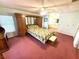 Bright bedroom with king-size bed, large wardrobe, vanity, and adjoining bathroom at 344 Mariner Dr, North Port, FL 34287