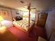 Cozy bedroom featuring four-poster bed, floral wallpaper border, and comfortable furnishings at 344 Mariner Dr, North Port, FL 34287