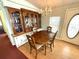 Formal dining area with wood table, china cabinet, and adjacent entry door at 344 Mariner Dr, North Port, FL 34287