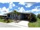 Charming single-story home featuring a covered carport, well-maintained lawn, and beautiful landscaping at 344 Mariner Dr, North Port, FL 34287