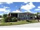 Charming single-story home featuring a screened in porch and well-maintained lawn with mature landscaping at 344 Mariner Dr, North Port, FL 34287