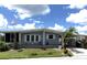 Charming single-story home featuring a screened in porch and well-maintained lawn with mature landscaping at 344 Mariner Dr, North Port, FL 34287
