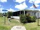 Charming single-story home featuring a screened in porch and well-maintained lawn with mature landscaping at 344 Mariner Dr, North Port, FL 34287