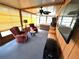 Bright Florida room with two seating areas, a hot tub, and wall mounted TV at 344 Mariner Dr, North Port, FL 34287