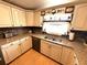 Kitchen featuring granite counters, a window over the sink, and custom cabinets at 344 Mariner Dr, North Port, FL 34287