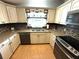 This charming kitchen features granite counters and stainless appliances at 344 Mariner Dr, North Port, FL 34287