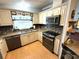 This kitchen features granite counters and backsplash and newer appliances at 344 Mariner Dr, North Port, FL 34287