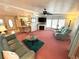 Open-concept living room with a fireplace, modern furniture, and seamless flow to the kitchen area at 344 Mariner Dr, North Port, FL 34287