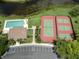 Aerial view showcasing community amenities, including a pool, tennis courts, and lush landscaping at 346 Roseling Cir, Venice, FL 34293