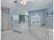 Bright bathroom featuring a large soaking tub, a walk-in shower, and a double vanity at 346 Roseling Cir, Venice, FL 34293
