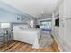 Bright main bedroom with wood floors, ceiling fan, and views of the pool area at 346 Roseling Cir, Venice, FL 34293