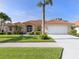 Charming single-story home boasting a lush lawn, beautiful landscaping, and a two-car garage at 346 Roseling Cir, Venice, FL 34293