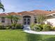 Elegant home entrance featuring double doors with decorative accents, complemented by well-maintained landscaping at 346 Roseling Cir, Venice, FL 34293