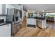 Open concept kitchen with stainless steel appliances, wood floors, and a breakfast bar for casual dining at 346 Roseling Cir, Venice, FL 34293
