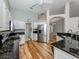 Open kitchen with stainless steel appliances, dark granite counters, and hardwood flooring at 346 Roseling Cir, Venice, FL 34293