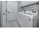Bright laundry room featuring a washer and dryer, with white tile flooring at 346 Roseling Cir, Venice, FL 34293