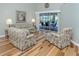 Inviting living room with hardwood floors and a glass sliding door to the pool area at 346 Roseling Cir, Venice, FL 34293
