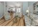 Bright living room featuring hardwood floors, arched doorways, and views into the dining room at 346 Roseling Cir, Venice, FL 34293