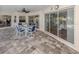 Covered patio with beautiful stone flooring and patio table, perfect for outdoor entertaining at 346 Roseling Cir, Venice, FL 34293